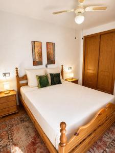 a bedroom with a large white bed with two lamps at Monte de Santa Pola in Gran Alacant