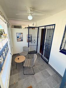 a balcony with chairs and a table and a table and chairs at Monte de Santa Pola in Gran Alacant