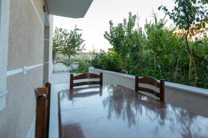 a table and two chairs sitting on a balcony at Sunrise Hotel Vila in Vlorë