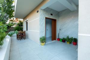 a balcony of a house with a table and chairs at Sunrise Hotel Vila in Vlorë +14 photos