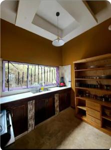 a large kitchen with a sink and a window at pumzika hill in Arusha +25 photos