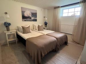 a bedroom with a large bed and a window at Holma Stångenäs Golf in Brastad