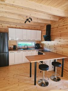 a kitchen with white cabinets and a wooden ceiling at Sarenka na Roztoczu in Nielisz +14 photos