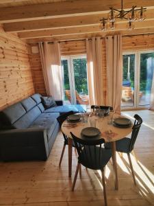 a living room with a table and a couch at Sarenka na Roztoczu in Nielisz