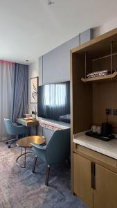 a room with chairs and a table and a bed at Golden New Hotel in Abha