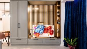 a living room with a painting on the wall at Briana Luxury Panoramic View in Cluj-Napoca