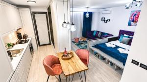 a small room with a table and chairs and a bed at Briana Luxury Panoramic View in Cluj-Napoca +25 photos
