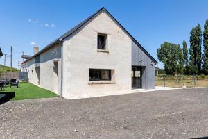 a house with a gambrel roof and a playground at Villa Flora 14 pers 5 chambres in Courcelles-de-Touraine