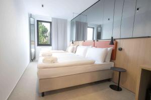 a bedroom with two beds with a mirror on the wall at WE Hotel EXPO Prague in Prague +22 photos