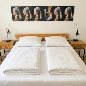 a bedroom with two beds and a painting on the wall at Longinus Quartier in Havixbeck