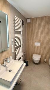 a bathroom with a white sink and a toilet at Longinus Quartier in Havixbeck +5 photos