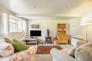 a living room with a couch and a fire place at 2 Bed in Beaminster oc-63136 in Stoke Abbott