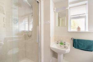 a white bathroom with a shower and a sink at 2 Bed in Beaminster oc-63136 in Stoke Abbott +24 photos