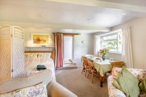 a living room with a couch and a table at 2 Bed in Beaminster oc-63136 in Stoke Abbott