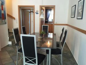 a dining room with a table and chairs at Residenz Seelust in Langeoog +2 photos