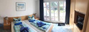 a living room with a couch and a window at Residenz Seelust in Langeoog