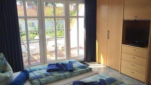 a bedroom with a bed and a large window at Residenz Seelust in Langeoog