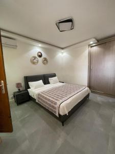 a bedroom with a large bed in a room at Résidence You Royal in Dakar +6 photos