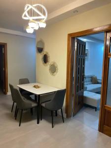 a dining room with a table and chairs and a couch at Résidence You Royal in Dakar