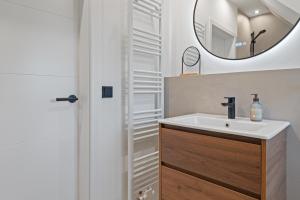 a bathroom with a sink and a mirror at Nordseebude Küstenglück in Sankt Peter-Ording +20 photos