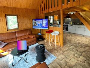 a living room with a couch and a tv in a kitchen at Kat in Cabourg