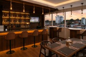 a restaurant with a bar with a view of a city at Hotel happy stay inn in Pashupatināth