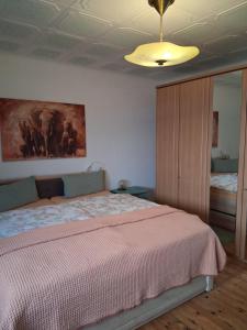a bedroom with a bed and a painting on the ceiling at Ferienwohnung Friedel und Käthe in Oberthal