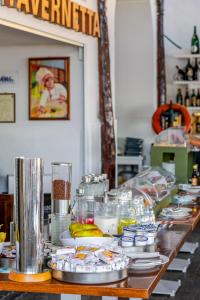 a long table with plates of food on it at Hotel Baia Di Puolo in Massa Lubrense +70 photos