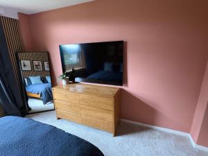 a bedroom with a dresser and a large mirror at Ravelston in Edinburgh