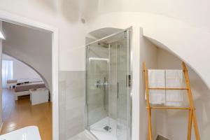 a bathroom with a shower with a glass door at Hotel Baia Di Puolo in Massa Lubrense