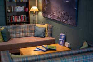 a living room with a couch and a table at Torridon Youth Hostel in Torridon