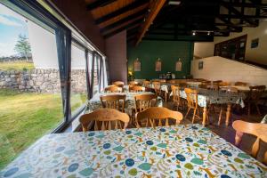 a dining room with tables and chairs and windows at Torridon Youth Hostel in Torridon +24 photos