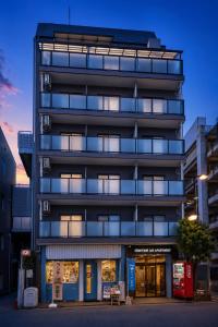 a tall building with a lot of windows at Sidihome 365 Apartment in Osaka