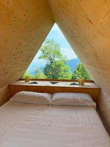 a bed in a small room with a window at Rifugio Pra La Peira in Villar Perosa
