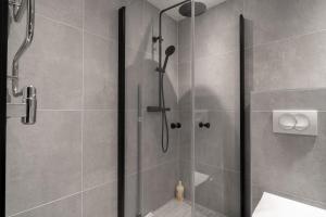 a shower stall with a glass door in a bathroom at View Studios in Åre +10 photos