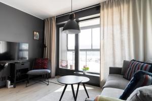 a living room with a couch and a table and a window at View Studios in Åre