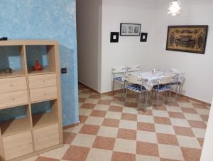a dining room with a table and a cabinet at Arenabeach in Martil
