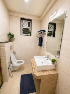 a bathroom with a sink and a toilet and a mirror at Rovio in Vagator +10 photos