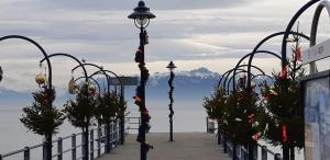 a street light with christmas decorations on a pier at Plage & Montagne - Appartement familial à proximité de la plage de Préverenges in Preverenges