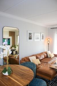 a living room with a couch and a table at White Orchid Luxury Apartment in Chartwell