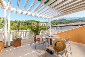 a patio with a table and chairs on a balcony at Apartments Grifone Lux in Herceg-Novi