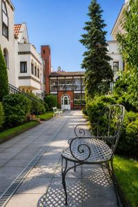 a bench sitting on a sidewalk in front of a building at Dzien Dobry Hostel in Gdańsk