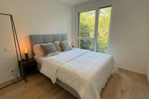 a bedroom with a bed with a large window at Les Terrasses de Lavaux-2 Appartement de Luxe avec Vue Panoramique et Piscine" in Chexbres +44 photos