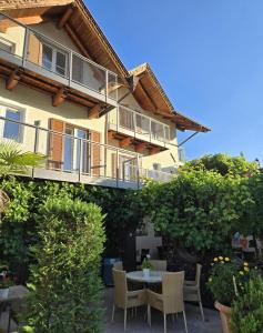 a patio with a table and chairs in front of a building at Fischerhof in Cortaccia