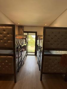 a room with three bunk beds and a doorway at Blue water house in Dar Bouazza