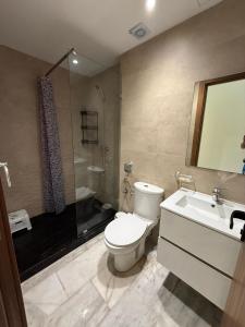 a bathroom with a toilet and a sink and a shower at Blue water house in Dar Bouazza