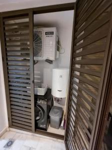 a room with a computer and a air conditioner at Blue water house in Dar Bouazza