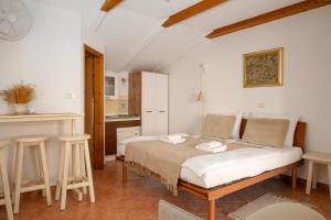 a bedroom with a bed in a room with a kitchen at San Mauro Countryside Retreat with Restaurant & Wine Cellar in Momjan