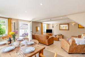a living room with a table and a couch at 2 Bed in Bridport oc-dc110 in Chideock