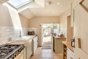 a kitchen with a sink and a stove at 2 Bed in Bridport oc-dc110 in Chideock